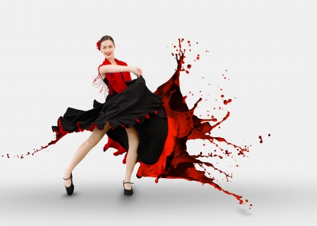 Flamenco dancer with dress turning to paint splashing on white backgroundの写真素材
