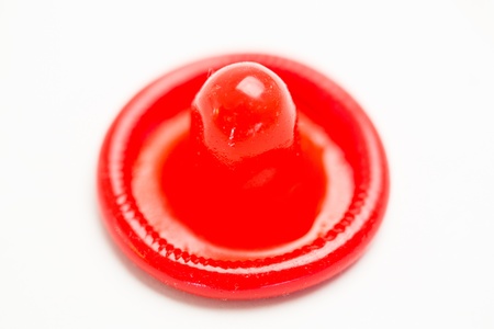Bright red condom on white backgroundの写真素材