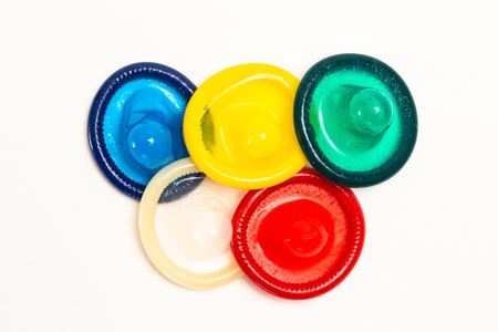 Five colourful condoms on white backgroundの写真素材