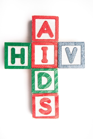 Wood blocks spelling aids and hiv in a cross shape on white backgroundの写真素材