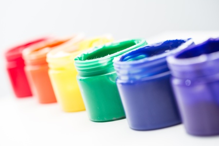 Rainbow paint pots in a line for gay pride on white backgroundの写真素材