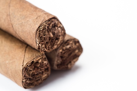 Three cigars stacked on white backgroundの写真素材