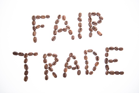 Fair trade spelled out in coffee beans on white backgroundの写真素材