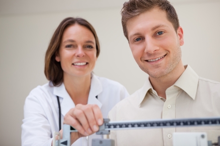 Patient getting scale adjusted by doctorの写真素材