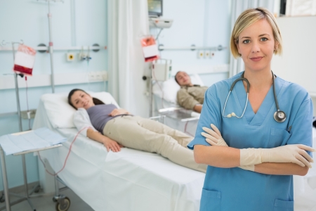 Nurse with arms crossed in hospital wardの写真素材