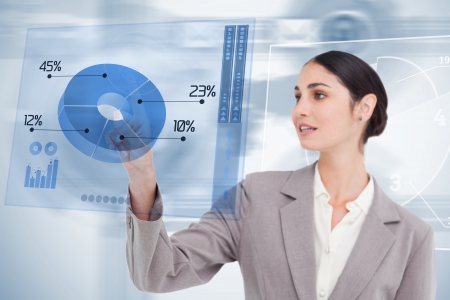 Businesswoman using colorful blue futuristic interface with her fingerの写真素材