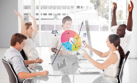 Cheerful business workers using colorful pie chart interface in a meetingの写真素材
