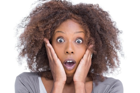 Amazed attractive woman gesturing on white backgroundの写真素材