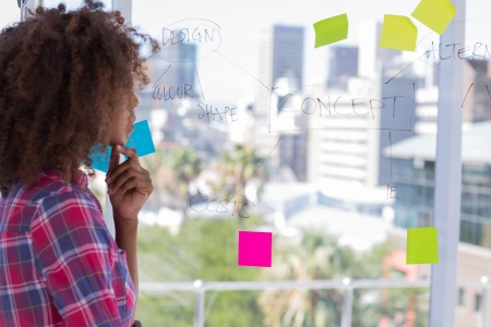 Designer looking at  design and concept flowchart on windowの写真素材