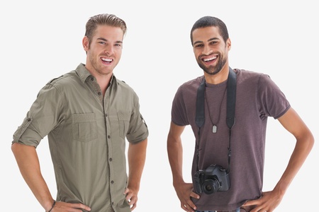 Photographer and his friend smiling at camera on white backgroundの写真素材