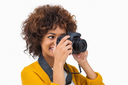 Pretty girl taking a photo on white backgroundの写真素材