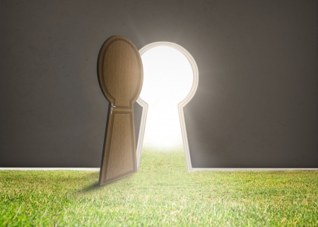 Doorway opening to bright light with grass in dark grey roomの写真素材