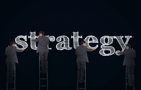Multiple image of a businessman writing strategy on a giant blackboardの写真素材