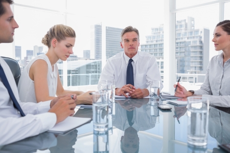 Serious businessman during a meeting with his employeesの写真素材