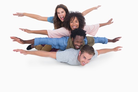 Friends leaning on each other on white surfaceの写真素材