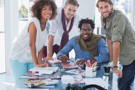 Designers smiling at camera in bright officeの写真素材