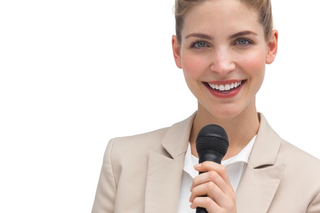 Classy businesswoman holding microphone on white backgroundの写真素材