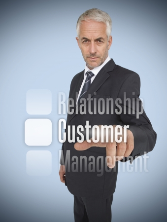 Businessman selecting the word customer on futuristic interfaceの写真素材