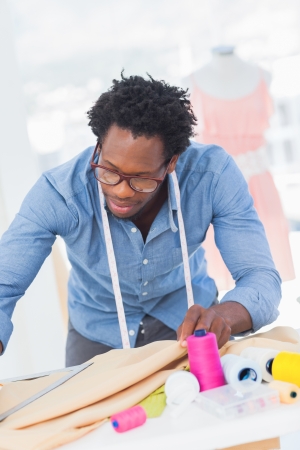 Fashion designer holding textile in a creative officeの写真素材