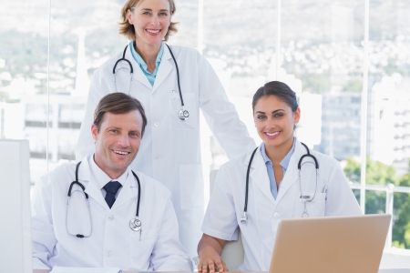 Group of doctors working together with a laptopの写真素材