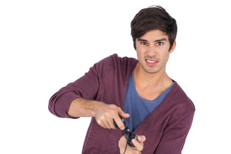 Concentrated man playing video games on a white backgroundの写真素材