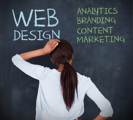 Doubtful businesswoman looking at a chalkboard Doubtful businesswoman looking at a chalkboard