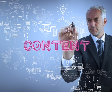 Businessman holding a marker and writing the word content against blue backgroundの写真素材