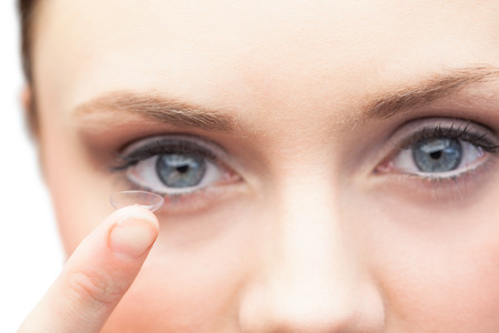 Pretty model on white background holding contact lensの写真素材