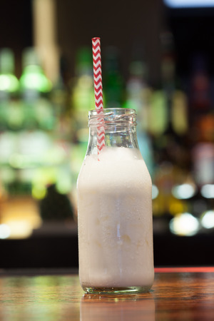 Close up on white russian with funny straw in a classy barの写真素材