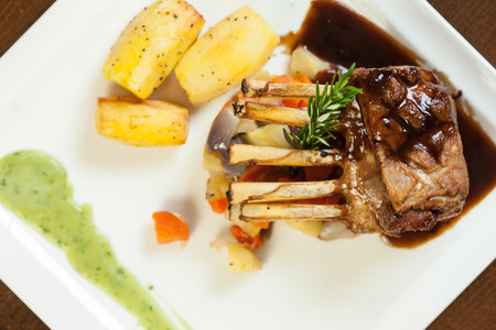Delicious rack of lamb dish with roast vegetable and potatoes served in classy restaurantの写真素材