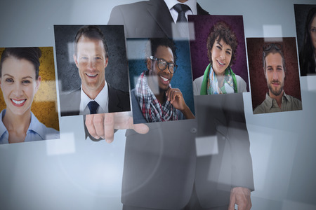 Businessman presenting profile pictures on digital interfaceの写真素材