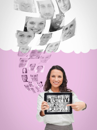 Smiling human resources director choosing future employees on digital tabletの写真素材