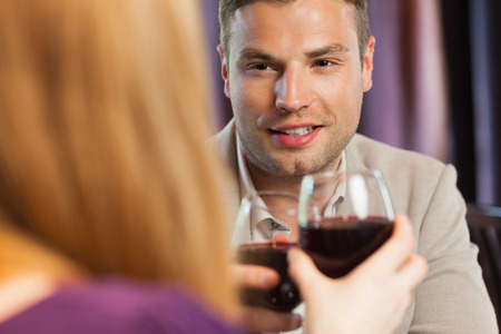 Happy couple having dinner together in a classy restaurantの写真素材
