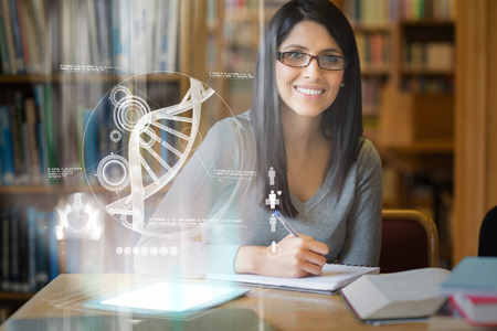 Smiling mature student studying medicine on digital interface in university library