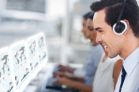 Call center staff at work on futuristic interfaces showing maps in modern officeの写真素材