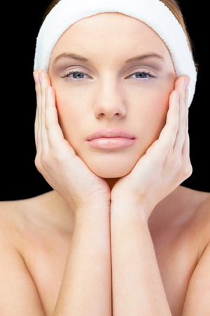 Peaceful young model on black background wearing headband の写真素材