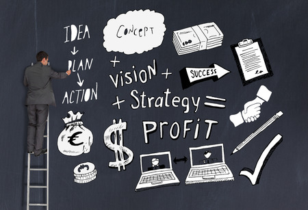 Rear view of businessman pointing at business plan black white standing on ladderの写真素材