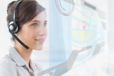 Pretty call centre agent smiling in an office