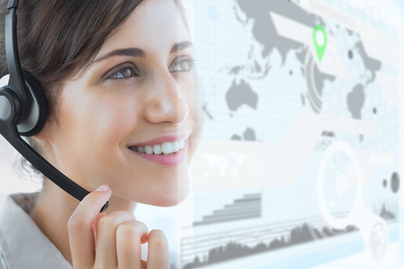 Brunette call centre agent smiling and looking away in office