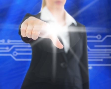 Composite image of a mid section businesswoman pointing on glowing screenの写真素材
