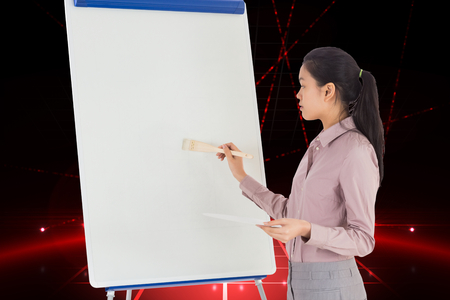 Businesswoman painting on an easel against cool nightlife lightsの写真素材