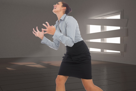 Furious businesswoman gesturing against digitally generated room with bordered up windowの写真素材