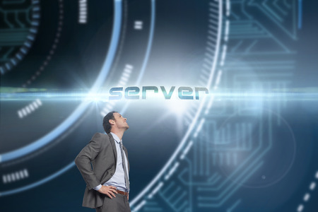 The word server and smiling businessman with hands on hips against futuristic technological backgroundの写真素材