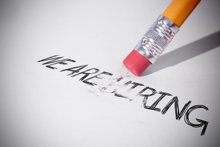 Pencil erasing the word we are hiring on paperの写真素材