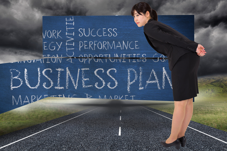 Serious businesswoman bending against 3d plane taking off over streetの写真素材