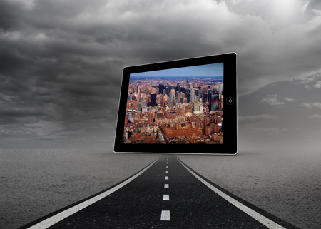 New york on tablet screen against street under stormy skyの写真素材