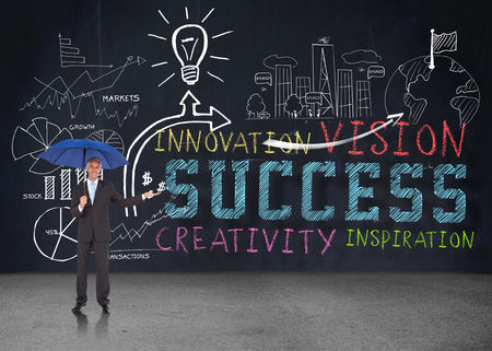 Peaceful businessman holding blue umbrella against brainstorm in grey roomの写真素材