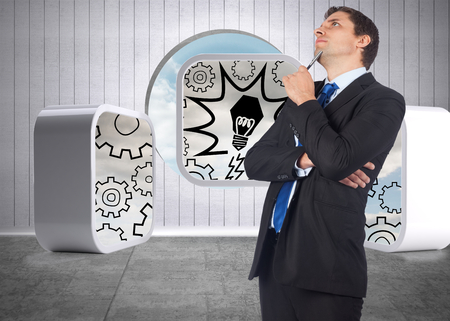 Thinking businessman holding pen against hole in wall to show skyの写真素材