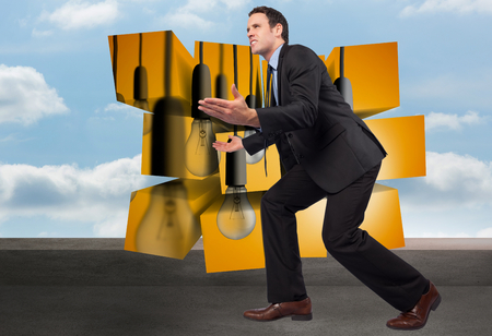 Businessman posing with arms outstretched against balcony and cloudy skyの写真素材
