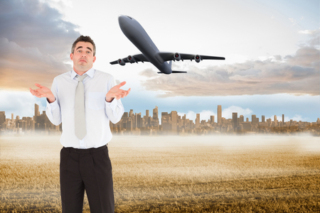 Portrait of a clueless businessman posing against large city on the horizonの写真素材